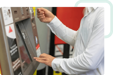 End user inserting a ticket into a vending machine