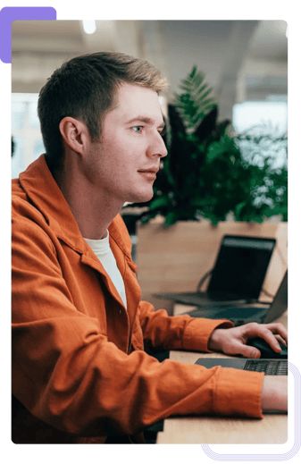 Cybersecurity account manager working on project proposal at the computer